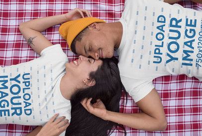 T-Shirt Mockup of a Couple Lying on a Blanket