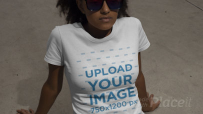 T-Shirt Video of a Young Woman with Sunglasses Sitting on the Ground 22822