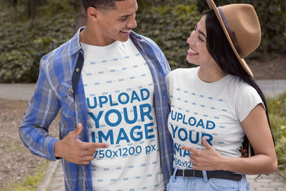 T-Shirt Mockup Featuring a Couple Pointing at Each Other