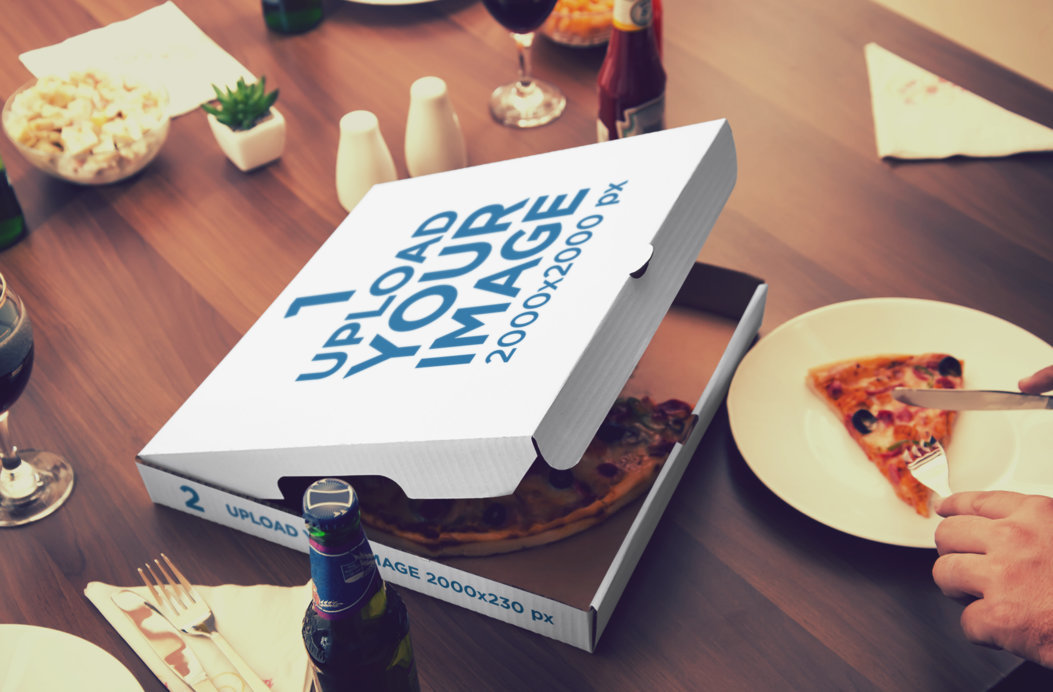 Placeit - Mockup of an Open Pizza Box Placed Next to a Person Cutting a ...