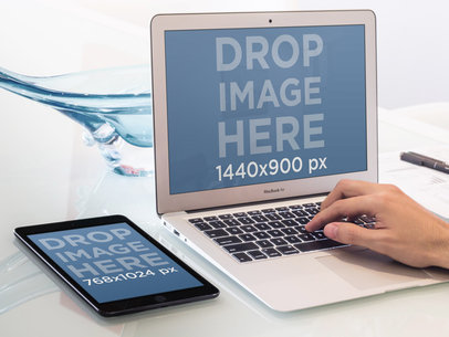 MacBook Air and iPad Mockup Featuring a Man's Hand 