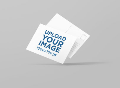 Front and Back View Mockup of Two Postcards Floating on a Plain Background