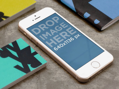 Mockup of an iPhone 5s Placed over a Concrete Surface