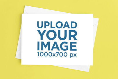 Mockup of a Greeting Card Placed over an Envelope on a Surface