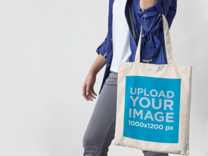 Mockup of a Canvas Tote Bag Being Carried by a Young Woman