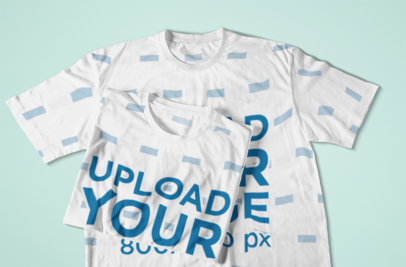 Mockup of a Folded Sublimated T-Shirt Over a Flat Laid One