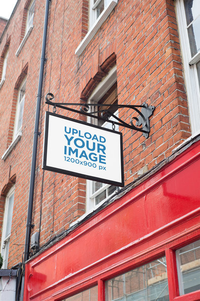 Mockup of a Store Sign Placed on a Brick-Wall Building