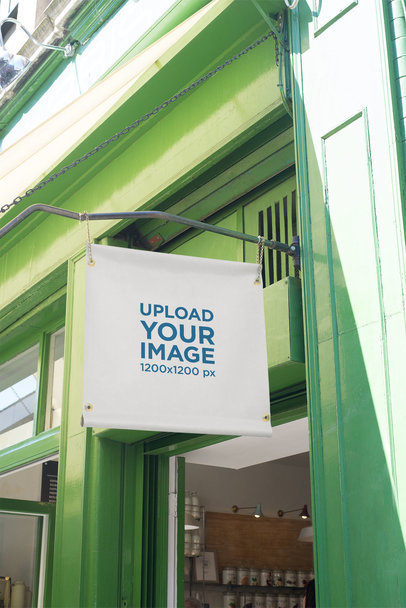 Mockup of a Squared Store Sign Placed on a Green Building