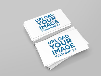 Mockup of Two Piles of Business Cards Against a Plain Surface 