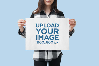 Mockup of a Woman Holding a Horizontal Poster 