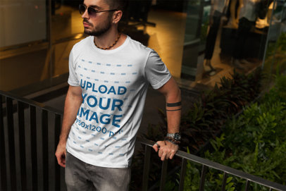 T-Shirt Mockup of a Cool Man Leaning on a Balcony