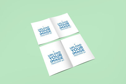 Mockup of Two Open Greeting Cards Lying on a Solid Surface