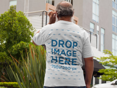 Back of a Middle Aged Man Wearing a T-Shirt Mockup on the Street