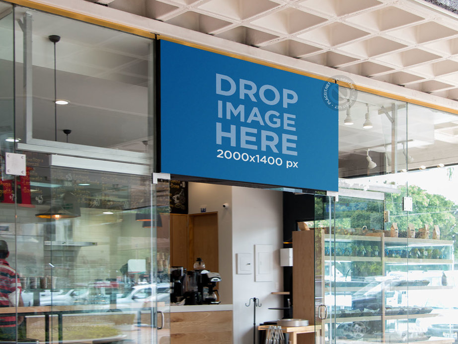 Placeit - Horizontal Sign Mockup Over a Bakery Shop