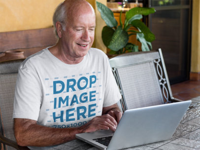 T-Shirt Mockup of a White Senior on His Laptop