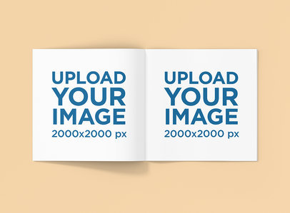 Mockup Featuring an Open Square Booklet over a Solid Color Backdrop 1512-el