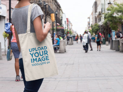 Mockup of a Tote Bag Carried by a Woman in the Street