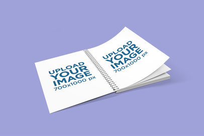 Mockup of a Spiralbound Notebook Turning Pages on a Plain Surface 1633-el1