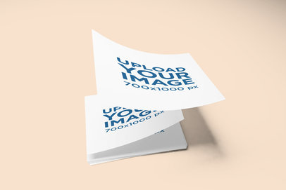 Mockup of a Pile of Flyers Landing on a Flat Surface 