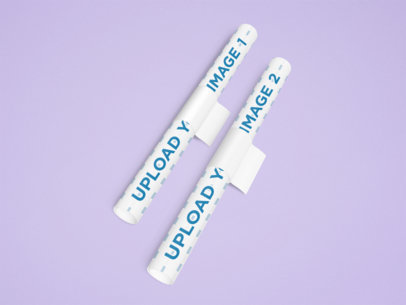 Mockup of Two Rolls of Wrapping Paper over a Customizable Surface