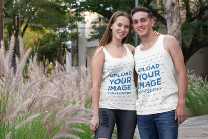 Mockup of a Happy Couple Wearing Tank Tops by Some Plants