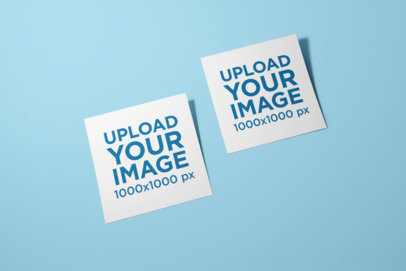 Mockup of Two Squared Flyers Lying on a Color-Customizable Surface