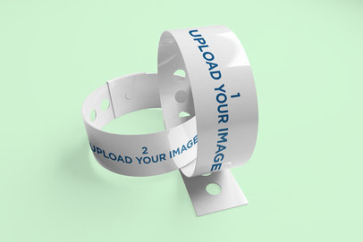 Mockup of Two Intertwined Vinyl Wristbands in a Flat Surface
