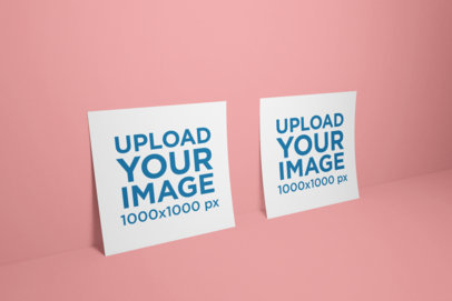 Mockup of Two Square Flyers Standing Against a Solid Background