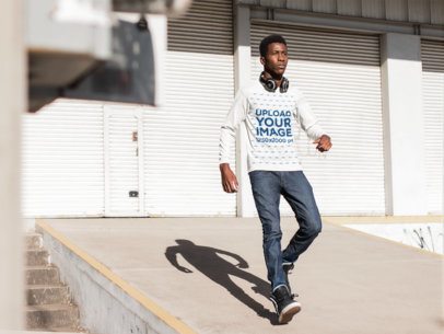 Long Sleeve T-Shirt Mockup Featuring a Young Man Near a Storage Area