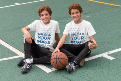 T-Shirt Mockup Featuring Two Red-Haired Twins at a Basketball Court 