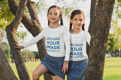 Long Sleeve Tee Mockup Featuring Two Sisters Climbing a Tree 