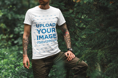 T-Shirt Mockup of an Adventurous Tattooed Man in Nature 