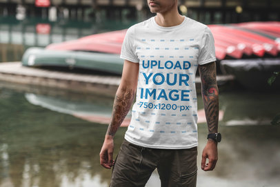 T-Shirt Mockup Featuring a Tattooed Man and Water in the Background