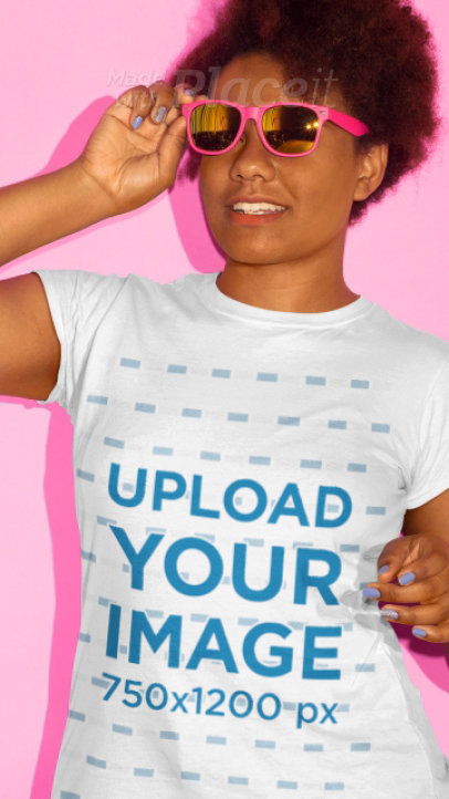 T-Shirt Video of a Young Woman with Kinky Hair Posing in Front of a Pink Backdrop