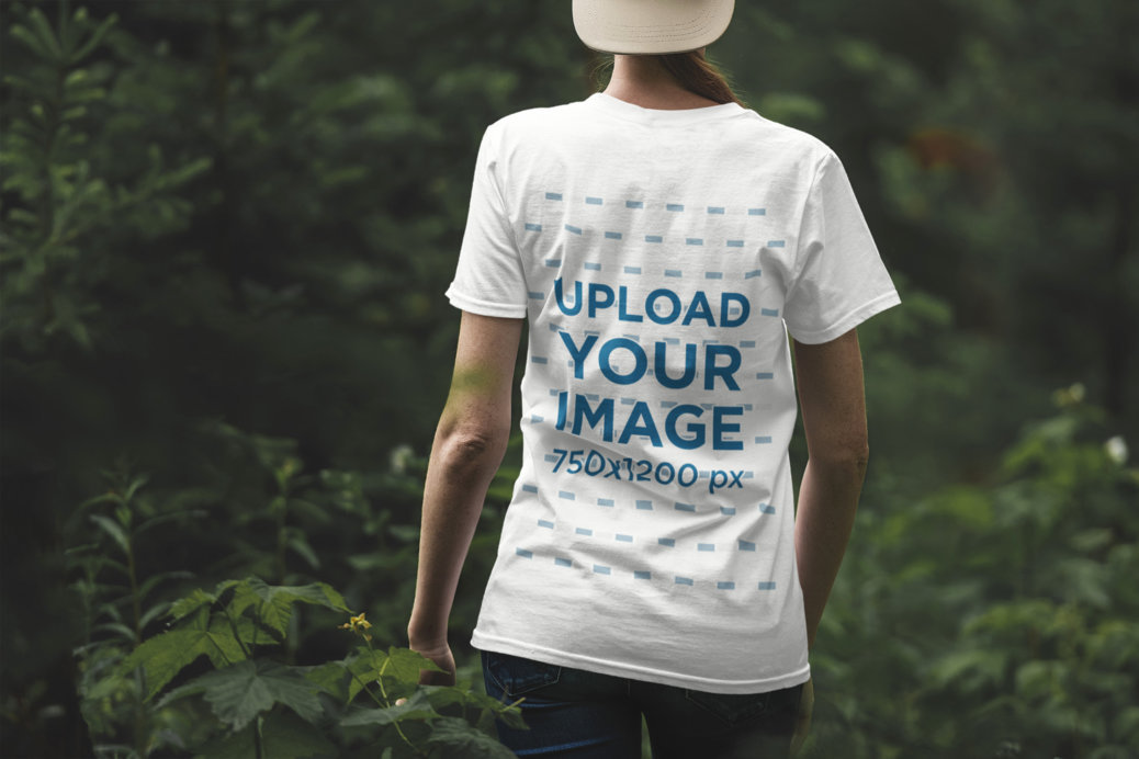 Back View T-Shirt Mockup of a Woman Surrounded by Wild Plants