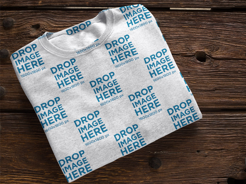 Folded Crew Neck Mockup Over a Wooden Table