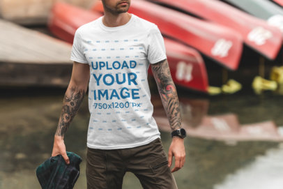 T-Shirt Mockup of a Man Posing by a Lake