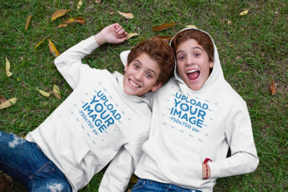 Pullover Hoodie Mockup Featuring Two Red-haired Twins Making Funny Faces 