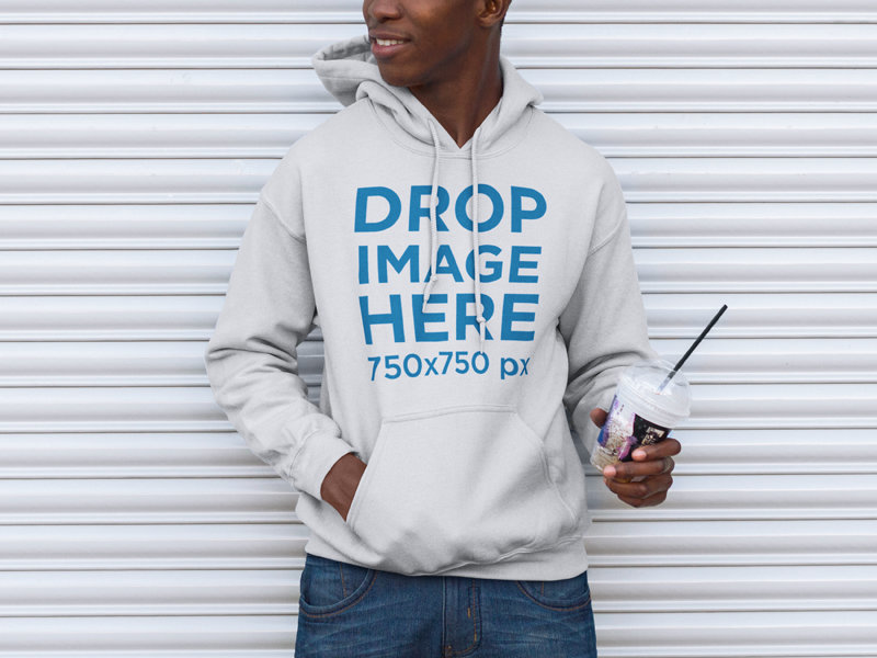 Mockup of a Young Man Wearing a Hoodie Holding His Coffee