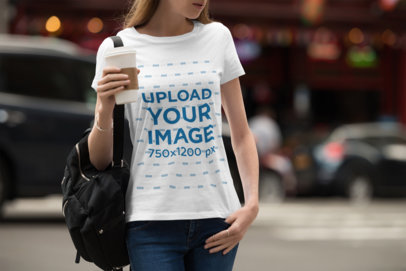 T-Shirt Mockup of a Woman Walking Down a Busy Street