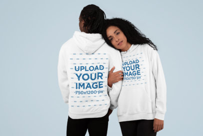 Both-Sides View Mockup of a Couple Wearing Pullover Hoodies at a Studio