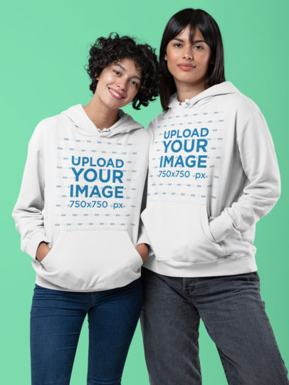 Pullover Hoodie Mockup of a Couple Posing at a Studio 
