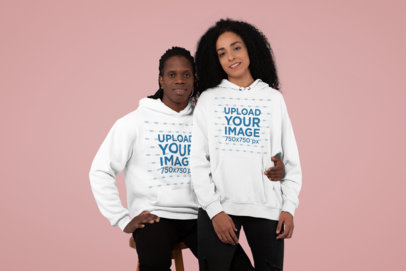 Pullover Hoodie Mockup of a Smiling Couple at a Studio