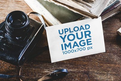 Mockup of a Postcard Beside a Vintage Camera