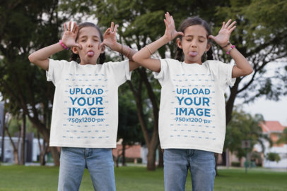 Mockup of Twin Girls Wearing T-Shirts and Making Funny Faces 