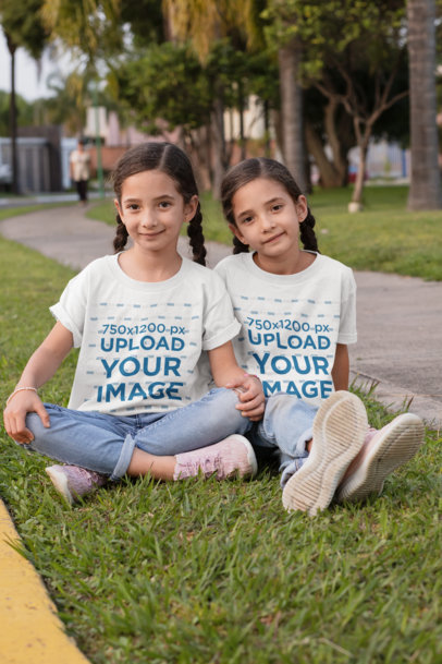 T-Shirt Mockup Featuring Twin Sisters at the Park