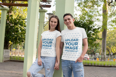 T-Shirt Mockup of a Couple Holding Hands at the Park 
