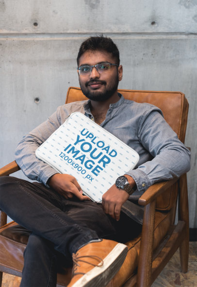 Laptop Sleeve Mockup Featuring a Man Sitting on a Leather Armchair 30858