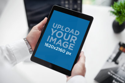 Mockup of a Man Holding an iPad at Work