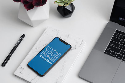 Mockup of an iPhone 11 Pro on an Elegant Office Desk